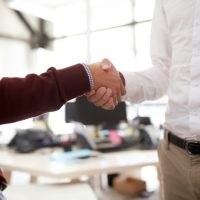 businessmen making handshake at office